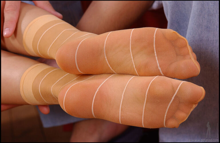 Angelina Crow poses in stockings for an adult footjob scene, with covered feet and close partnered fetish action kept in focus across the gallery. image 3