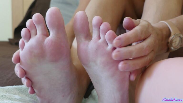 Natalie K begins with playful feet attention before turning it into a relaxed, explicit footjob sequence. image 3