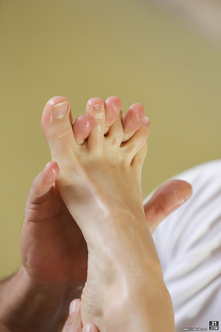 Alecia Fox mixes sensual toe sucking with a hands-on footjob, giving equal attention to her soles and polished toes. image 4