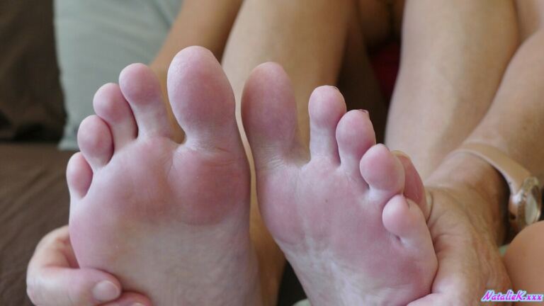 Natalie K begins with playful feet attention before turning it into a relaxed, explicit footjob sequence. image 4