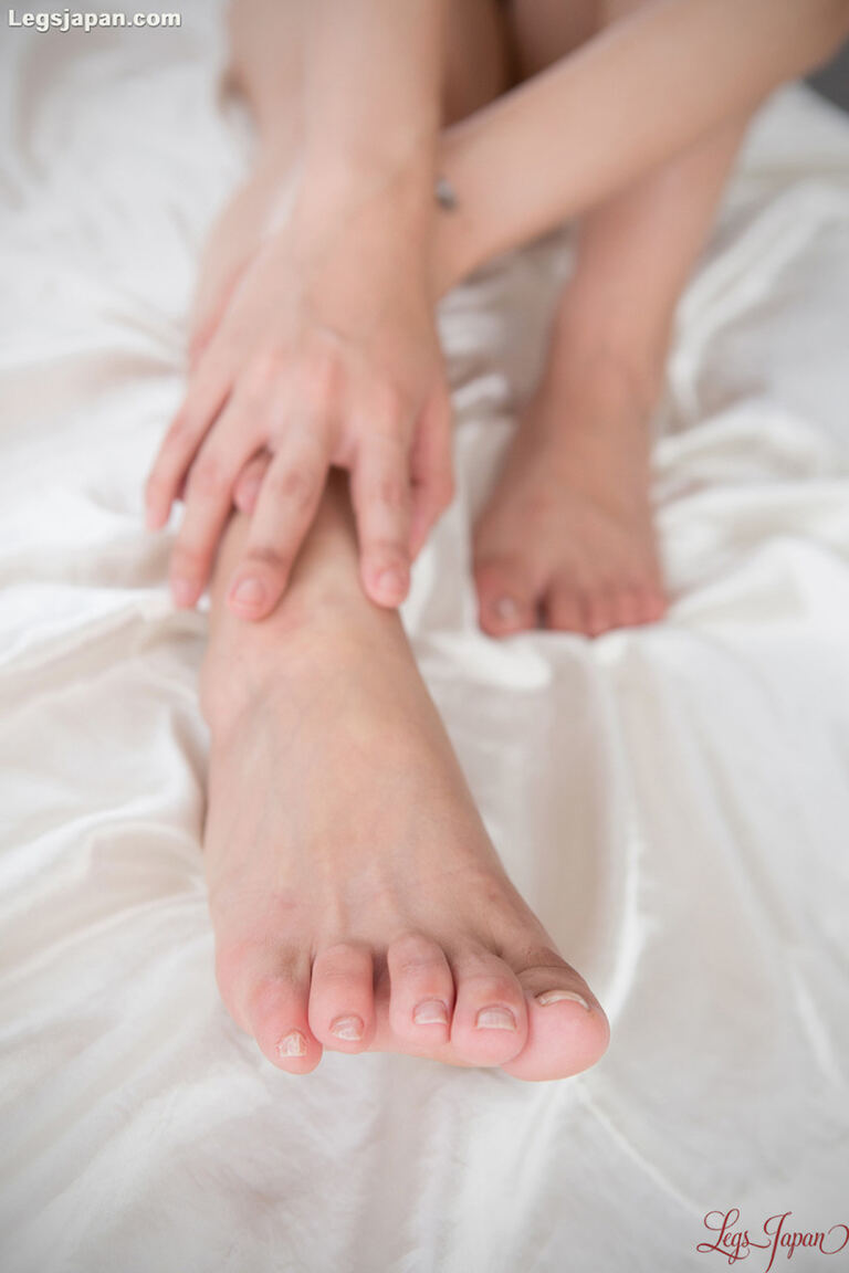 This feet-first gallery follows a leggy Japanese model through a footjob and an explicit close-up finish on her feet. image 7